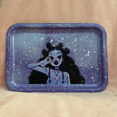 a blue tray with an image of a woman holding her hand up to her face