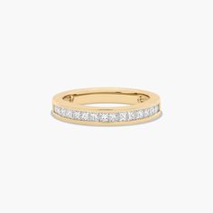 a yellow gold ring with princess cut diamonds