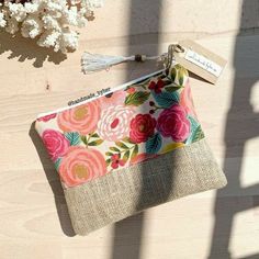 a flowered pouch sitting on top of a wooden table