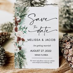 save the date card with pine cones and evergreen leaves on it, surrounded by pine cones