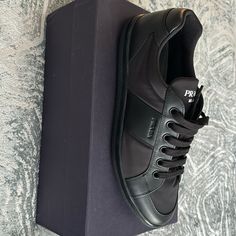 New Men’s Prada Sneakers Black Calf Leather Sneakers With Rubber Heel Cap, Designer Low-top Sneakers For Business, Prada Shoes Outfit Men, Designer Black Sneakers With Rubber Heel Cap, Designer Black Leather Sneakers, Designer Black Sneakers With Stitched Sole, Prada Sneakers Mens, Masculine Black Low-top Sneakers, Prada Mens Shoes