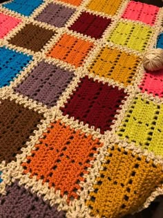 a crocheted blanket that is on top of a table