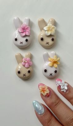 four small plastic bunnies with flowers on them