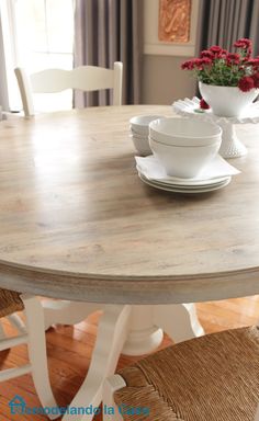 a table with white plates and bowls on it