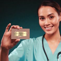 a woman in scrubs holding up a business card