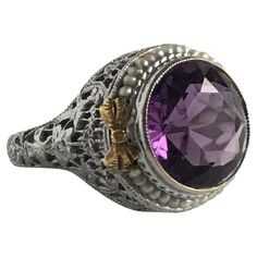 Details: Stunning Edwardian period amethyst, seed pearl and 14K white and yellow gold filigree ring! We love the sweet bow details on the shoulders of the setting! The stone measures 11mm, and the ring is 8mm above the finger at the highest point on the ring, and estimated weight of amethyst is between 3.5-3.75 carats. The filigree is beautiful on this ring, and is in lovely shape. This is a stunning ring—you will not be disappointed! Please ask all necessary questions prior to placing an order. Measurements: The size is 5 1/2 US and can be sized for a fee. Condition: The overall all condition of this ring is very good. Filigree Ring Gold, Gold Filigree, Filigree Ring, Seed Pearl, Cocktail Rings, The Sweet, Jewelry Rings, Amethyst, Yellow Gold