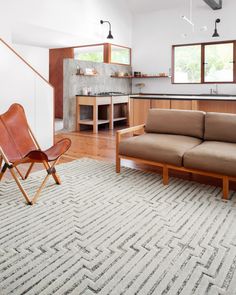 a living room filled with furniture and a rug