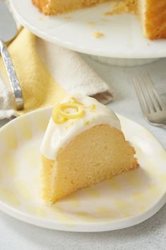 a slice of lemon cake on a plate with a fork and napkin next to it