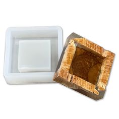 a wooden box with a white lid and a brown square in the middle on a white background