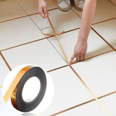 a person is using tape to measure the floor with their hands and feet on it