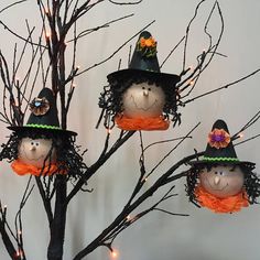 halloween decorations are hanging on the branches of a tree