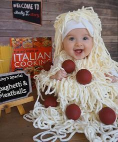 a baby dressed up in spaghetti and meatballs for halloween costume party with italian cooking sign