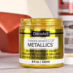 a jar of metallic paint sitting on top of a table