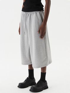 It is a comfy and stylish wide baggy fit sweatpant. The sweatpant has trendy bermuda design and has elastic band waist, which makes comfy fit. The pant is made of cotton and polyester blend fabric.- Elastic band waist- Drawstring on the waist- Side pockets- Basic, sporty Oversized Cotton Sporty Joggers, Casual Oversized Drawstring Sweatpants, Oversized Sweats With Elastic Waistband For Streetwear, Sporty Oversized Sweatpants With Elastic Waistband, Oversized Cotton Bottoms With Drawstring, Urban Cotton Sweatpants For Loungewear, Oversized Cotton Comfortable Joggers, Oversized Cotton Joggers, Oversized Comfortable Cotton Joggers