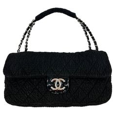 RARE Chanel Black Cloquèe XL Classic Flap in good condition. Black textured nylon in quilted diamond pattern trimmed with silver hardware and black patent leather. Silver CC logo upon front magnetic snap closure which opens via single flap to a gray nylon interior with with one side zip pocket. Overall good condition. Clean exterior, corners and edges. Signs of use inside with some discoloring stains of main lining and ink stains on interior of zip pocket. Very rare design only made for one season. XL flap size perfect for any occasion. Measurements: 15"x8"x5" 9" strap drop Chanel Vintage Bag, Vintage Chanel Bag, Chanel Clutch, Chanel Suit, Structured Shoulder, Patent Leather Handbags, Chanel Vintage, Ink Stain, Black Textures