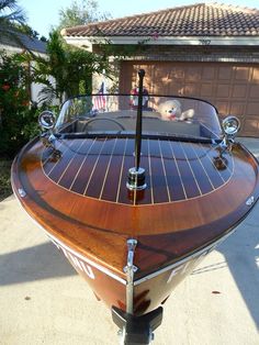 a wooden boat sitting on top of a driveway