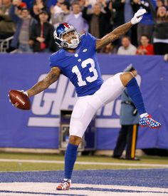 a football player with his arm in the air and one leg out as if to catch a ball