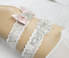 "--Rhinestone Wedding Garter, Crystal Garter Set,Off White Lace band Bridal Garter, Wedding Garter, Keepsake and Toss Garter Set-GT005 -- Beautiful custom sized bridal garters made with off white lace and clear crystal rhinestones in silver color settings . The keepsake applique is measured at 2\"width and 5\"long. The toss garter is 5/8\"width and 3\" long satin bow . These garters will be a stunning addition for your special day! Sample is an off-white stretch lace. Lace width: 1 1/2\" keepsak Adjustable Bridal Accessories With Rhinestones, Adjustable Rhinestone Bridal Accessories, Adjustable Rhinestone Bridal Accessories For Wedding, White Rhinestone Bridal Accessories For Ceremony, White Bridal Accessories With Rhinestones For Ceremony, White Bridal Sets, Crystal Garter, Garter Wedding, Wedding Garters