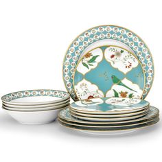 a set of four plates with flowers and birds on them