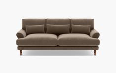 an image of a couch with pillows on the top and bottom half, in beige color