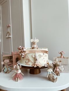 a birthday cake decorated with figurines on a table