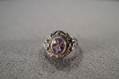 I am offering you this vintage sterling silver, wedding band stacker design ring. It features an oval shaped bezel set genuine amethyst stone. This stones is all set in a single stone setting.   There is fabulous scrolled raised relief design work here.  It is measuring app. 3/4 inch, by  It is currently a size 7.5, though I am sure it could be sized up or down. It weighs app. 7 grams. Look at the detail of the design work of this vintage ring Simply breathtaking. This ring came out of an estate Vintage Silver Amethyst Ring Birthstone, Antique Oval Amethyst Ring For Anniversary, Vintage Amethyst Ring With Accent Stones For Anniversary, Antique Oval Amethyst Anniversary Ring, Vintage Oval Amethyst Ring For Wedding, Vintage Oval Amethyst Wedding Ring, Vintage Birthstone Ring With Bezel Setting, Antique Amethyst Ring Stamped 925 For Anniversary, Vintage Silver Amethyst Ring For Anniversary