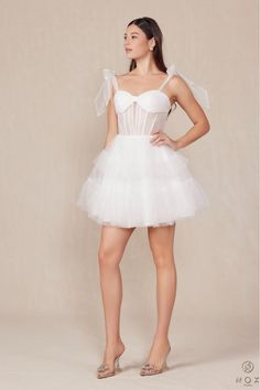 How dreamy is this White Tulle A-Line Mini?! Tulle Tie straps meet a ruched bandeau style bust and corset style bodice and flow into a layered tulle skirt. This dress will have you twirling on the dance floor all night long! Finished with an invisible zipper. Final Sale. Looking for a different size? Message us to inquire about availability to special order in sizes 00-16, don't forget to include the date of your event! Tulle Corset, Layered Tulle Skirt, Romper And Jacket, On The Dance Floor, White Tulle, Blazer With Jeans, Corset Style, Romper Dress, The Dance