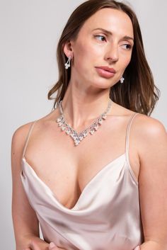 Our Megan Glam Cubic Z Necklace Set is designed to elevate and enhance any look. The statement Necklace is detailed with an all around semi stones and rhinestone design, the adjuster allows you to wear this to your best fitting. Its the perfect everyday piece. SizeLength : 14 in.Extender : 4.5 in. Drop : 1.25 in. QualityOne Size. Adjustable fit. Oxidized Metal Coating for quality endurance. ImportedNECZ2026R Wedding Rhinestone Necklace With Diamond Accents, Crystal Bridal Necklace With Diamond Accents, Bridal Crystal Necklace With Diamond Accents, Dazzling Crystal Necklaces For Formal Occasions, Evening Crystal Necklace With Sparkling Stones, Evening Crystal Necklaces, Elegant Crystal Embellished Jewelry For Gifts, Crystal Necklace For Evening, Glamorous Formal Necklace With Sparkling Stones