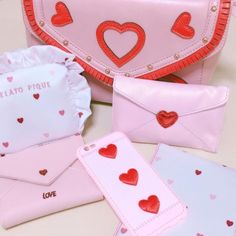 pink and red purses with hearts on them