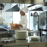 a chef is in the kitchen preparing plates for dinner or desserts on the counter