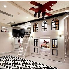 a child's bedroom with black and white chevron rugs on the floor