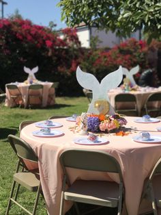 a table set up for a party with plates and napkins