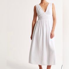 Easy-Fitting Dress In Our Lightweight Crinkle Texture Fabric, Featuring Smocked Elasticated Waistband, Functional Tie-Back Detail, Ruching Details Along The Shoulders, Deep-V Neckline And A Flowy Skirt. Casual Crinkle Texture Dress For Daywear, Linen Smocked Dress For Daywear, Casual Smocked Linen Dress With Ruched Detail, Casual Linen Smocked Dress With Smocked Back, Beach Linen Midi Dress With Smocked Bodice, White Linen Midi Dress With Smocked Back, Summer Smock Maxi Dress For Daywear, Ruched Summer Smocked Dress For Daywear, Summer Smocked Dress With Ruched Detail For Daywear