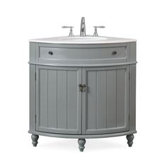 a bathroom vanity with a white sink and grey wood accents on the cabinet door is shown