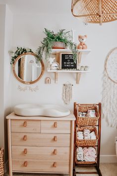 a baby's room with a crib, dresser and mirror