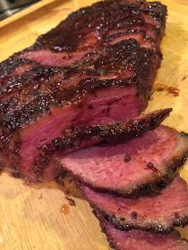 a large piece of meat sitting on top of a wooden cutting board