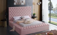 a pink bed sitting in a bedroom on top of a hard wood floor