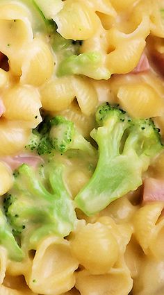 macaroni and cheese with broccoli on it is shown in close up