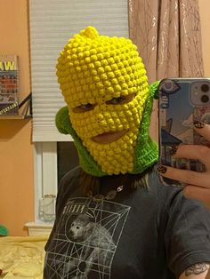 a man taking a selfie in front of a mirror with a lego mask on