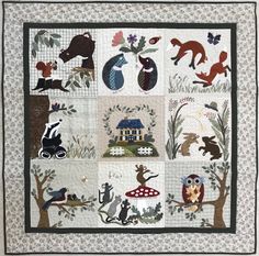 a quilt with animals and trees on it