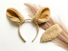 an animal ears headband made out of wool and fake fur on top of a white surface