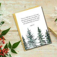 a christmas card with watercolor trees on it