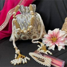 Silver Potli Bag For Bride, Beaded Purse For Wedding Day Bag For Mother Of Groom Gift Proposal Bag For Bridesmaid. The Drawstring Bag Comes In 3 Colors Baby Pink, Silver And Gold. Please Choose Your Color In The Options. Our Baby Pink, Silver And Gold Beaded And Zardozi Work Potli Is A Stunning And Functional Accessory That Can Be Used To Stylishly Carry Your Essentials. The Potli Is Made Of Silk Fabric. The Beaded And Zardozi Work Is Elaborated And Detailed, Adding A Glamorous Touch To The Potl Embellished Embroidered Fabric For Wedding, Embroidered Fabric Embellished For Navratri Wedding, Embroidered Fabric Embellished For Wedding And Navratri, Wedding Embellished Embroidered Fabric For Navratri, Festive Pearl Embroidered Fabric For Eid, Elegant Pink Embroidered Fabric For Navratri, Pearl Embroidered Fabric For Wedding And Eid, Eid Festive Pearl Embroidered Fabric, Wedding Embroidered Fabric With Pearl Embroidery For Eid