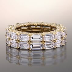 An undoubtedly sophisticated and bold choice. This ring features two rows of emerald-cut diamonds running along the band's circumference. Bringing an extra dazzling effect to the ring is a scalloped detail on the shank's inner edge, fully dotted with round diamonds. Pick this ring if you're looking for a statement-making jewelry gift for the discerning maximalist in your life. Blue Wedding Band, Something Blue Wedding, Eternity Rings, Diamond Anniversary Rings, Emerald Cut Diamonds, Ring Size Guide, Custom Engagement Ring, Eternity Bands, Diamond Gemstone