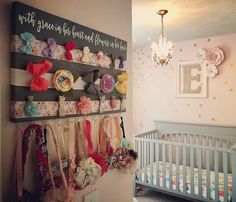 a baby's room with a crib and wall hangings