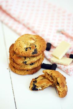 cookies with blueberries are stacked on top of each other next to a piece of butter