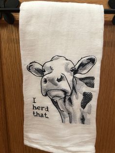 a white towel with a black and white drawing of a giraffe on it