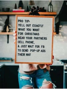 a woman holding up a sign that says pro tip yell out exactly what you want for christmas near your partners cell phone and just wait for fo