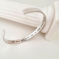 "The cuff bracelet comes with the hidden engraving: \"We love you and are so very proud of you\" But you can change or add an front engraving too. Also you can change the font Size Adjustable ! You can bend the cuff a little to open and close it on your wrist and it will stay in the shape you need Features: - Personalized Gift - Long Personalized  - Birthday gift for her - Adjustable silver cuff - Two sides custom engravable - Hypoallergenic Sterling Silver - Custom Engraving up to 45 characters (8-10 words) - Skinny Stacking Bracelet - Gift wrapping Details: 925 Sterling Silver  The  thickness is 1mm Just write me any words, names or dates you want to get engraved! Please choose the Style Width 1/5 inch (6mm)  Circumference 6.4 inch (Europe Size - 16 cm ) Why buy our customized jewelry? ♥ Adjustable Silver Cuff Bracelet For Promise, Meaningful Engraved Bracelets For Promise, Stainless Steel Bangle Bracelets For Promise, Meaningful Engraved Promise Bracelets, Stainless Steel Bangle Bracelet For Promise, Minimalist Stainless Steel Cuff Bracelet As Gift, Engraved Stainless Steel Meaningful Bracelets, Meaningful Engraved Stainless Steel Bracelets, Personalized Stainless Steel Promise Bracelet