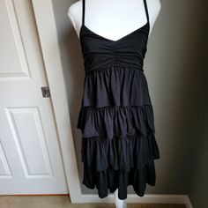 Unworn! It's New Without Tags. I've Had It Hanging In My Closet Since I Bought It, I Had Actually Completely Forgotten It Was There And Then We Moved! It's In Perfect Condition And Very Cute. Would Look Great Paired With Gladiator Sandals Or A Duster And A Pair Of Wedges. Transition Into Fall With Opaque Tights, Thigh High Boots And A Slouchy Sweater. I'm Busty, At A 36e, So Don't Be Afraid Of That Bust. This Is One Of The Few Dresses We Can All Rock And Look Great In. Hits Me Below The Knee Casual Black Summer Tiered Dress, Casual Black Tiered Summer Dress, Black Tiered Dress For Spring, Black Tiered Dress For Beach In Summer, Black Tiered Dress For Summer Beach, Black Tiered Beach Dress For Summer, Black Tiered Summer Beach Dress, Black Ruched Tiered Dress, Black Tiered Ruched Dress